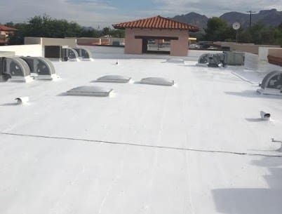 flat roof with roof coating, multiple skylight installations, in a tucson home by a roofing company